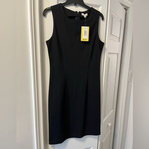 Black sleeveless dress, staple piece for office attire.